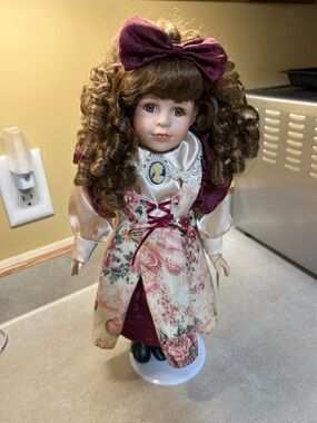 Collectors Choice Porcelain Collectible Doll with Burgundy Bow and Floral Dress